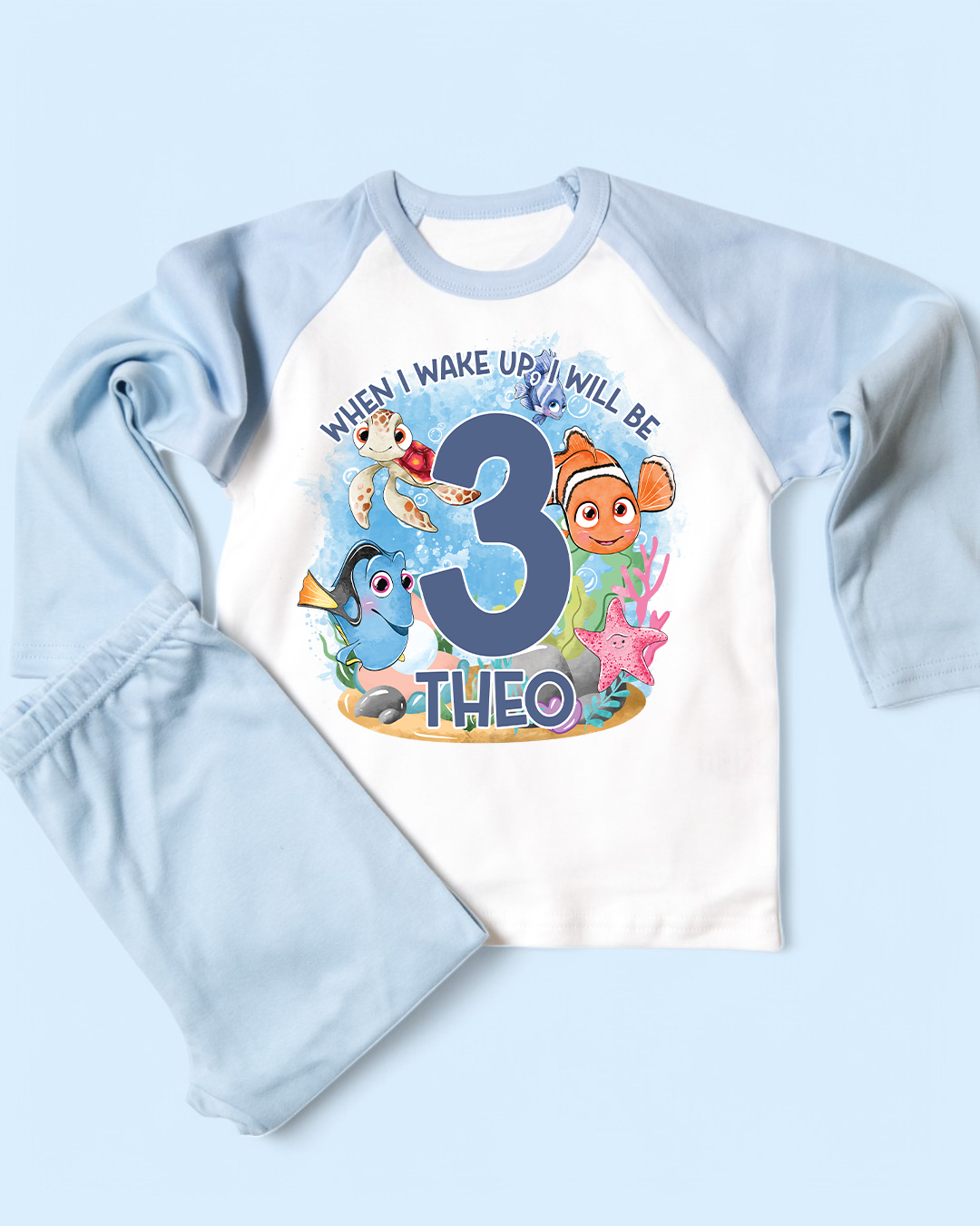 Children's birthday pyjamas with finding nemo and text on a light blue background